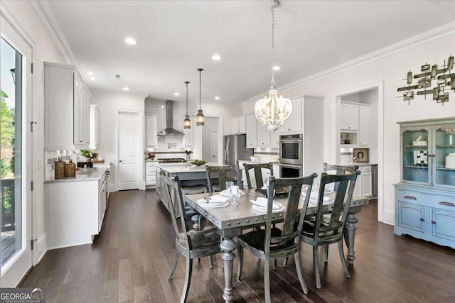 dining area with dark hardwood / wood-style flooring, a chandelier, ornamental molding, and a wealth of natural light