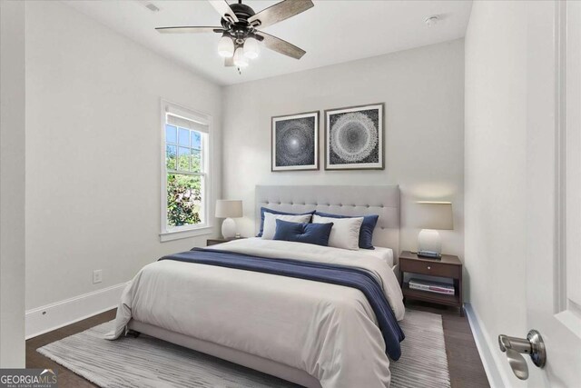 bedroom with ceiling fan and hardwood / wood-style flooring