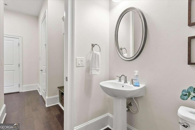 bathroom featuring toilet and wood-type flooring