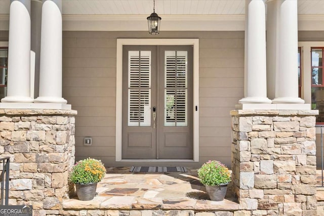 doorway to property with a porch and french doors