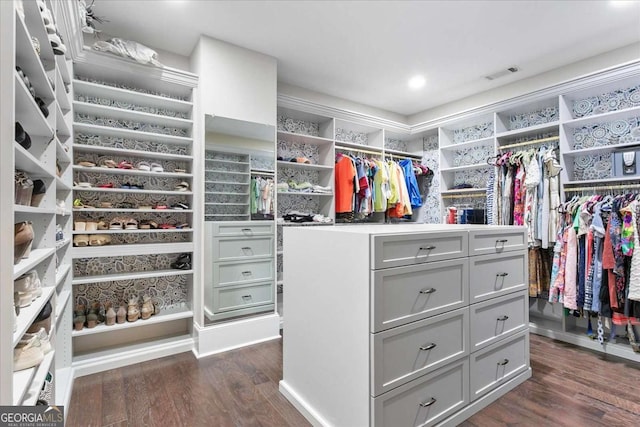 walk in closet with dark hardwood / wood-style flooring