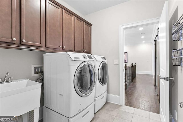 washroom featuring sink, cabinets, light tile patterned flooring, and independent washer and dryer