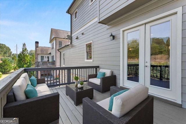 wooden deck with french doors and an outdoor hangout area