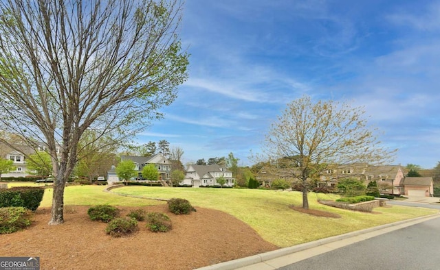 view of property's community with a lawn