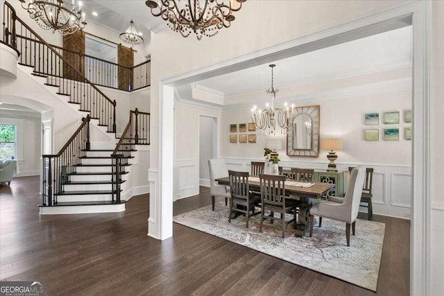 dining room with dark wood-type flooring, crown molding, and a chandelier