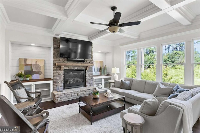 living room with coffered ceiling, beamed ceiling, ceiling fan, a fireplace, and hardwood / wood-style flooring