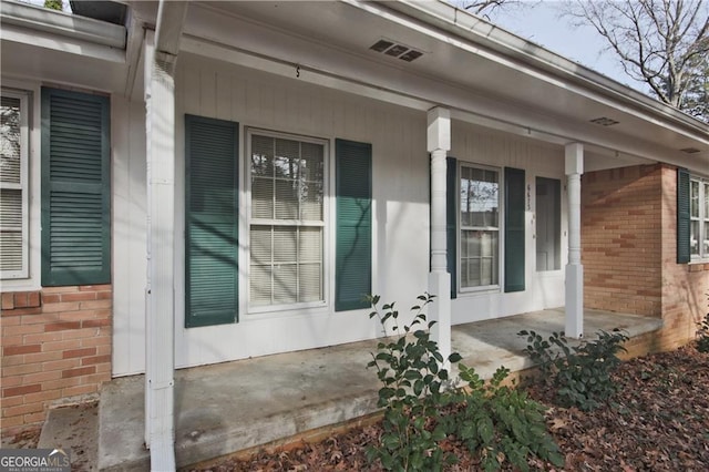 view of side of property featuring covered porch