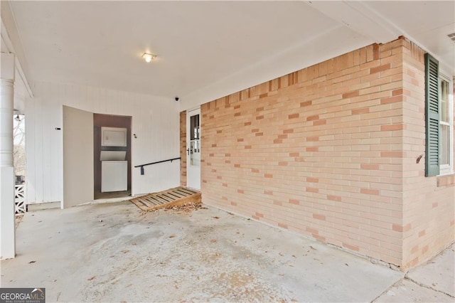 unfurnished room with brick wall