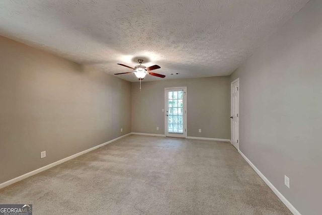 carpeted empty room with a textured ceiling and ceiling fan