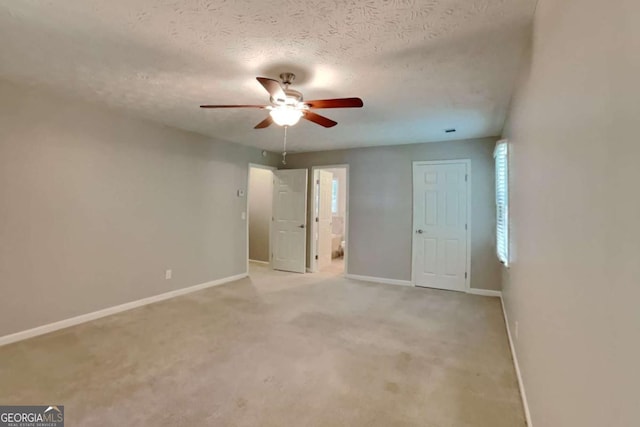 carpeted empty room with a textured ceiling and ceiling fan