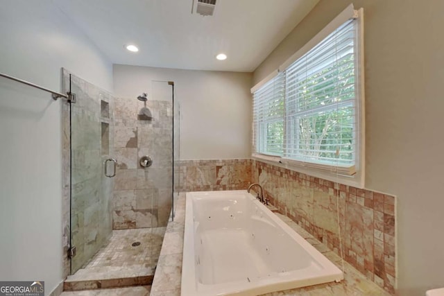 bathroom featuring separate shower and tub