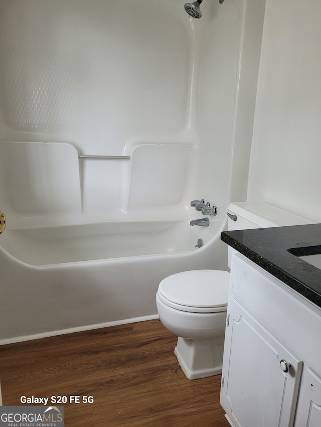 bathroom featuring toilet, vanity, and hardwood / wood-style flooring