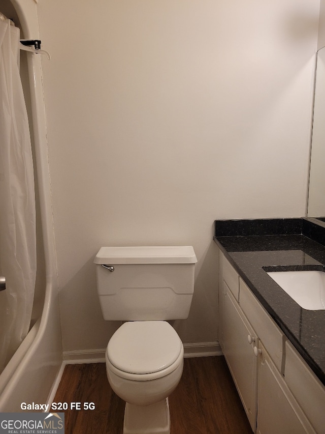 full bathroom featuring toilet, shower / tub combo, vanity, and hardwood / wood-style flooring