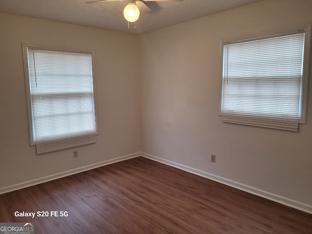 empty room featuring ceiling fan and dark wood-type flooring