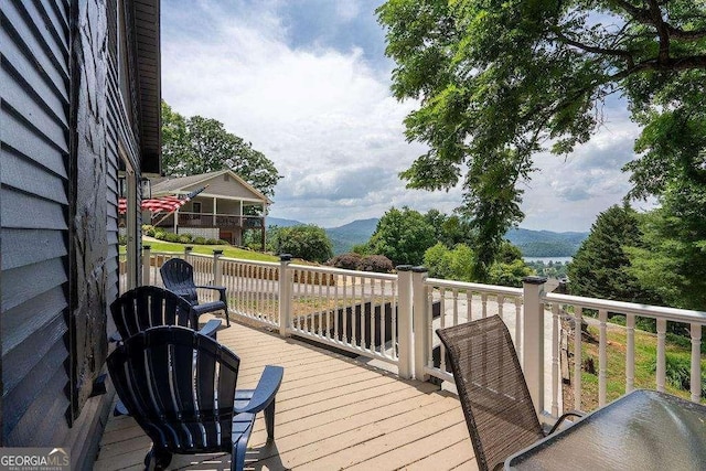 wooden deck featuring a mountain view