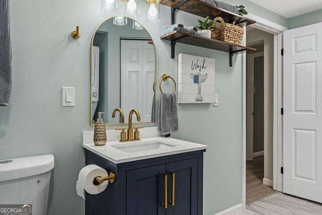 bathroom with vanity, toilet, and wood-type flooring