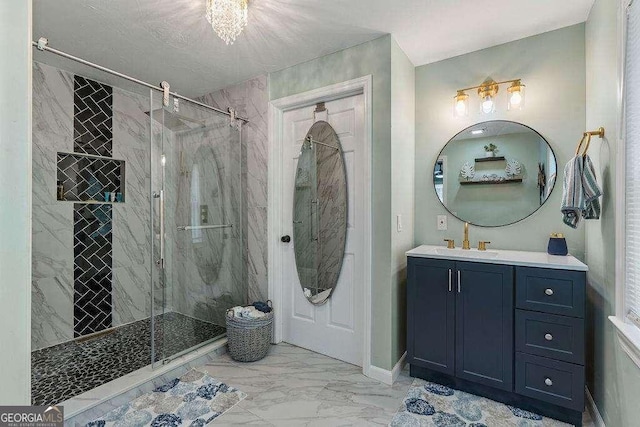 bathroom with a tile shower and vanity