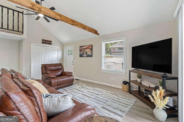 living room featuring ceiling fan, beam ceiling, high vaulted ceiling, and light hardwood / wood-style flooring