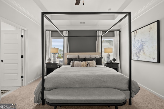 carpeted bedroom with ceiling fan and ornamental molding