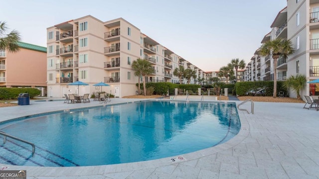 view of swimming pool with a patio