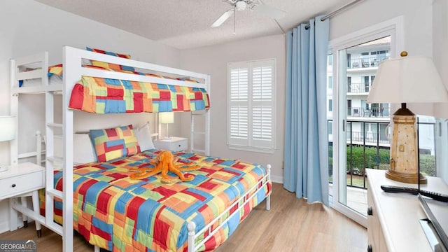 bedroom with access to exterior, ceiling fan, a textured ceiling, and light wood-type flooring