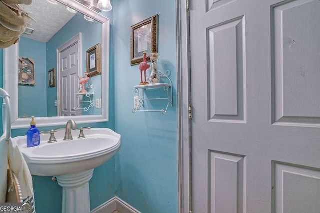 bathroom with a textured ceiling