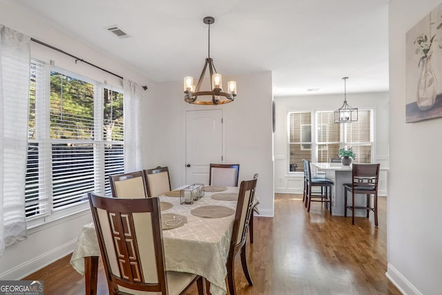 dining room featuring an inviting chandelier and hardwood / wood-style flooring