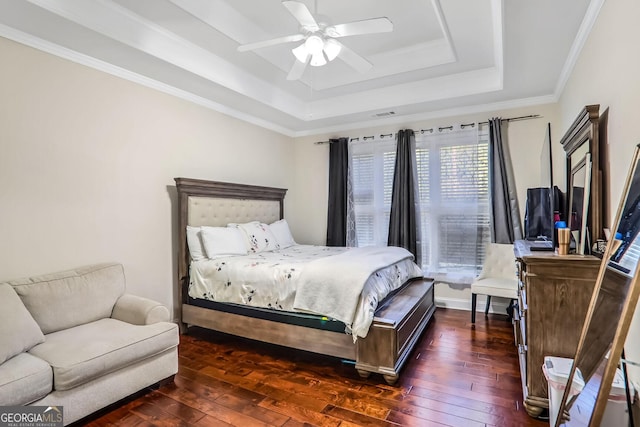 bedroom featuring a raised ceiling, ceiling fan, crown molding, and dark hardwood / wood-style floors