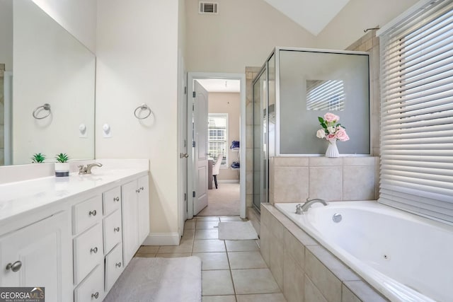 bathroom with lofted ceiling, vanity, tile patterned floors, and independent shower and bath