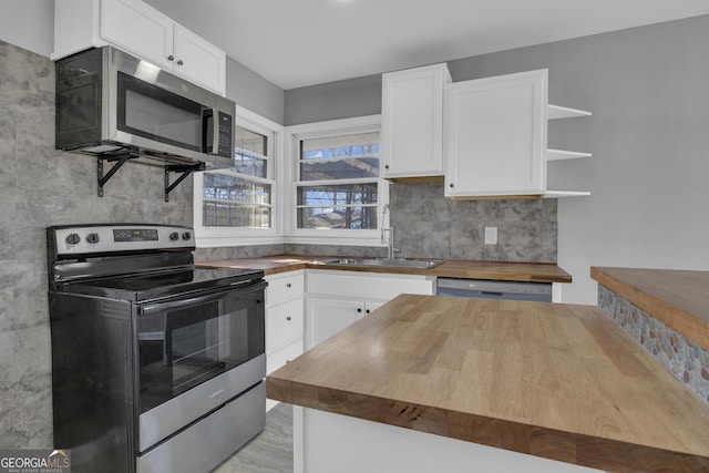 kitchen featuring stainless steel fridge and white cabinetry