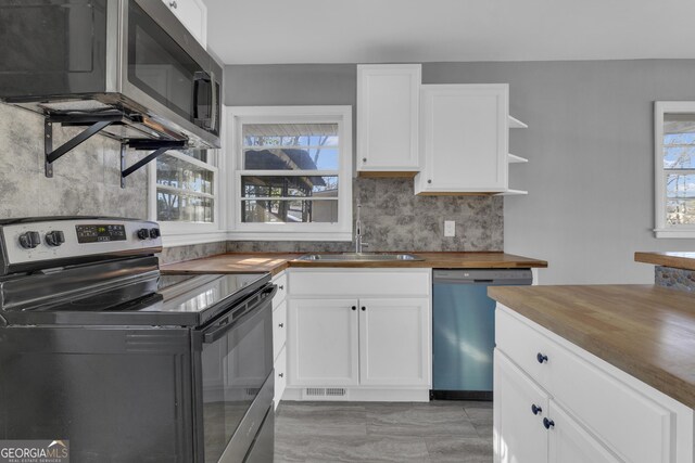 laundry room with dark wood-type flooring and stacked washer / dryer