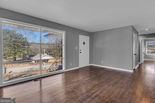 unfurnished bedroom featuring dark hardwood / wood-style flooring and a closet