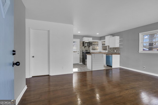 kitchen featuring wooden counters, stainless steel appliances, tasteful backsplash, white cabinets, and sink