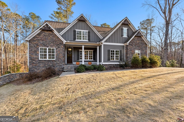 craftsman-style home with covered porch and a front lawn