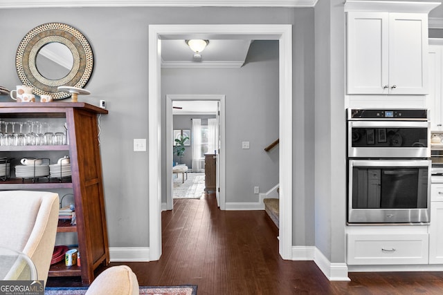 interior space featuring white cabinets, crown molding, stainless steel double oven, and dark hardwood / wood-style floors