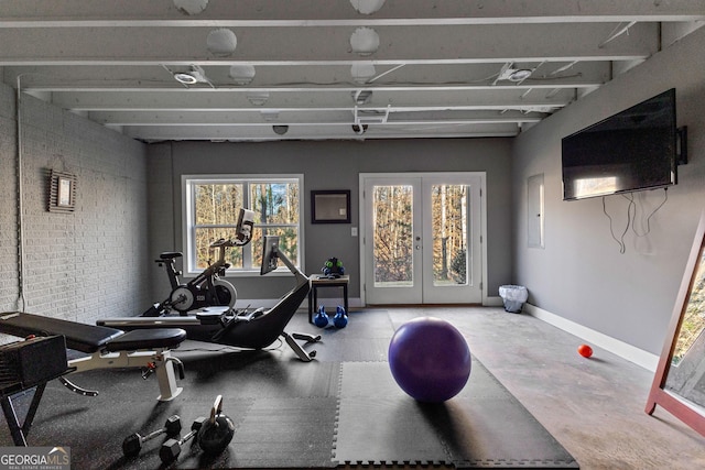 workout area with brick wall and french doors