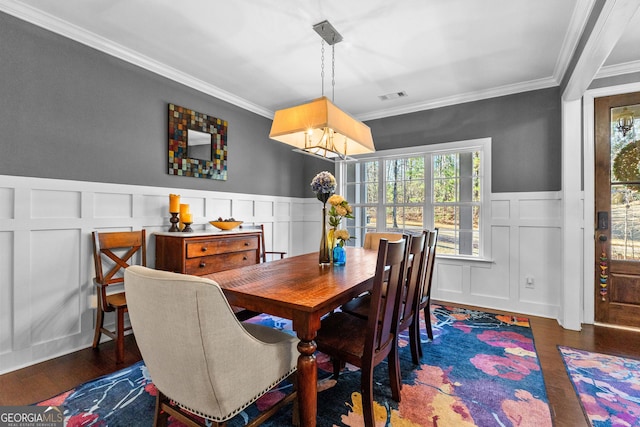 dining space featuring crown molding and dark hardwood / wood-style floors