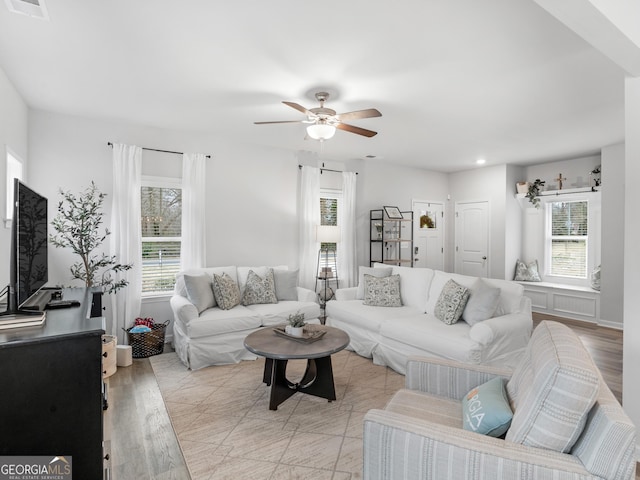 living room with ceiling fan and light hardwood / wood-style floors