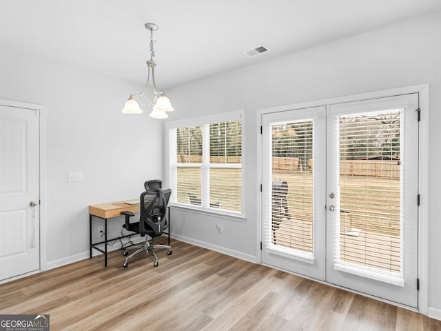 office with french doors, a chandelier, and light hardwood / wood-style flooring