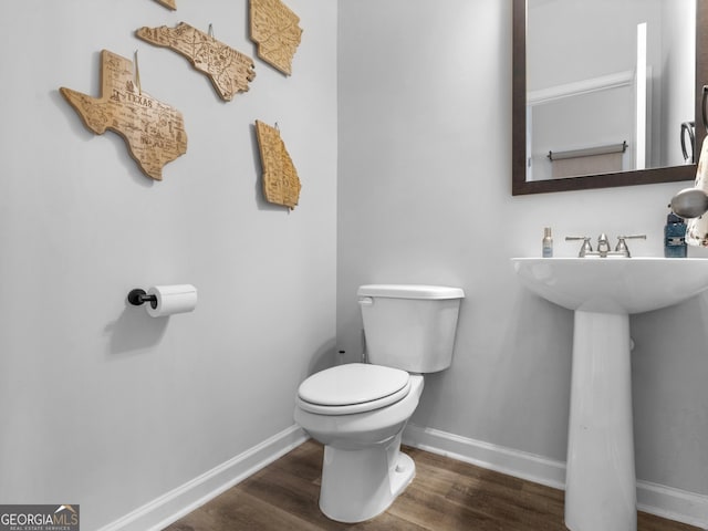 bathroom featuring toilet and hardwood / wood-style floors