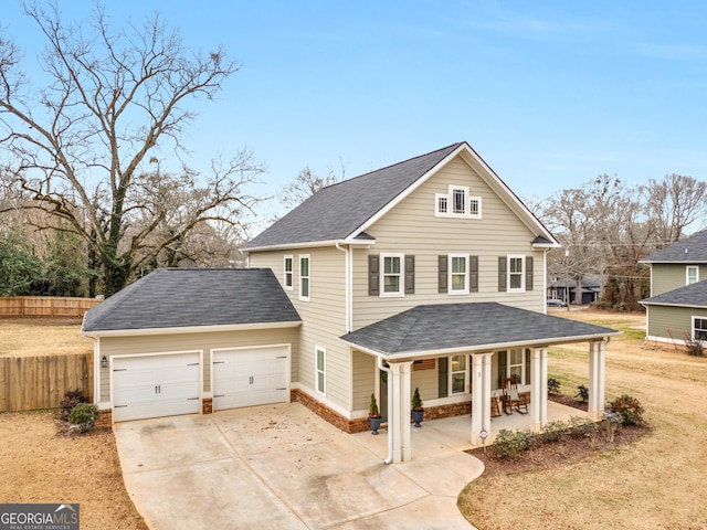 view of front of house featuring a porch, a garage, and a front yard