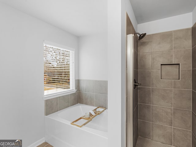 bathroom with shower with separate bathtub