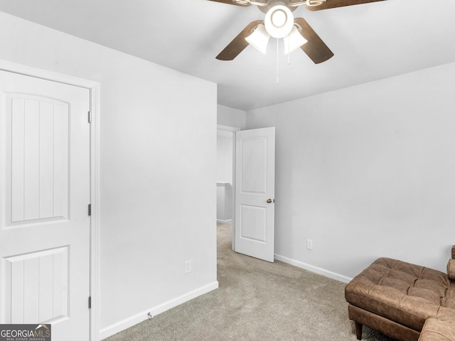 living area with ceiling fan and light carpet