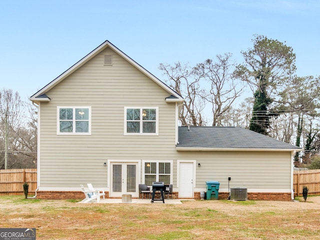 back of property featuring a patio, a lawn, central AC unit, and french doors