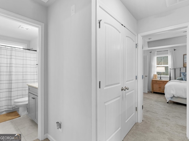 interior space with a shower with curtain, vanity, and toilet