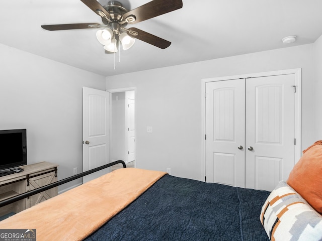 bedroom with ceiling fan and a closet