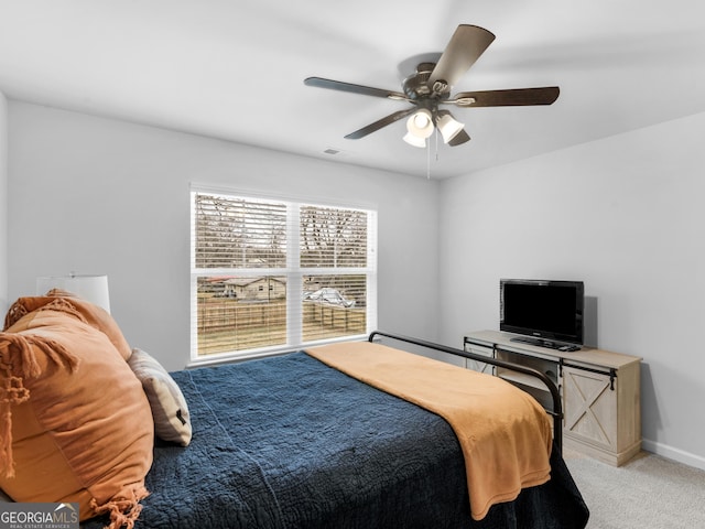 bedroom with light colored carpet and ceiling fan