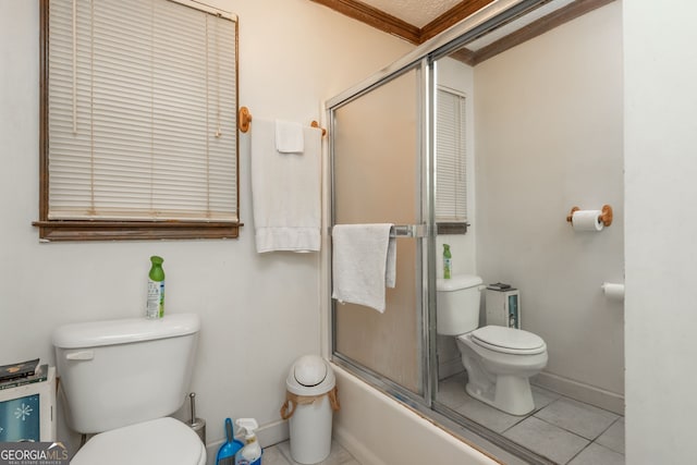 bathroom with combined bath / shower with glass door, tile patterned flooring, and toilet