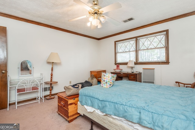 carpeted bedroom featuring a textured ceiling, ornamental molding, and ceiling fan