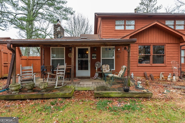 rear view of property featuring a wooden deck